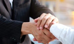 lawyer shaking hands with car accident client