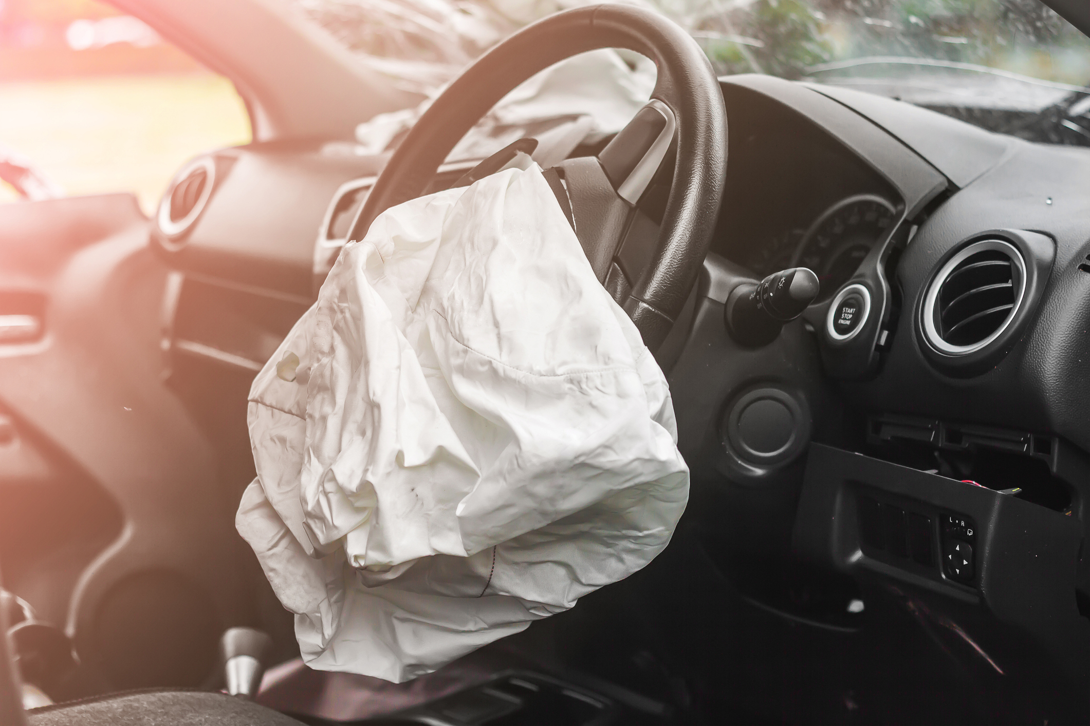 Interior driver’s side view of 2 deployed airbags