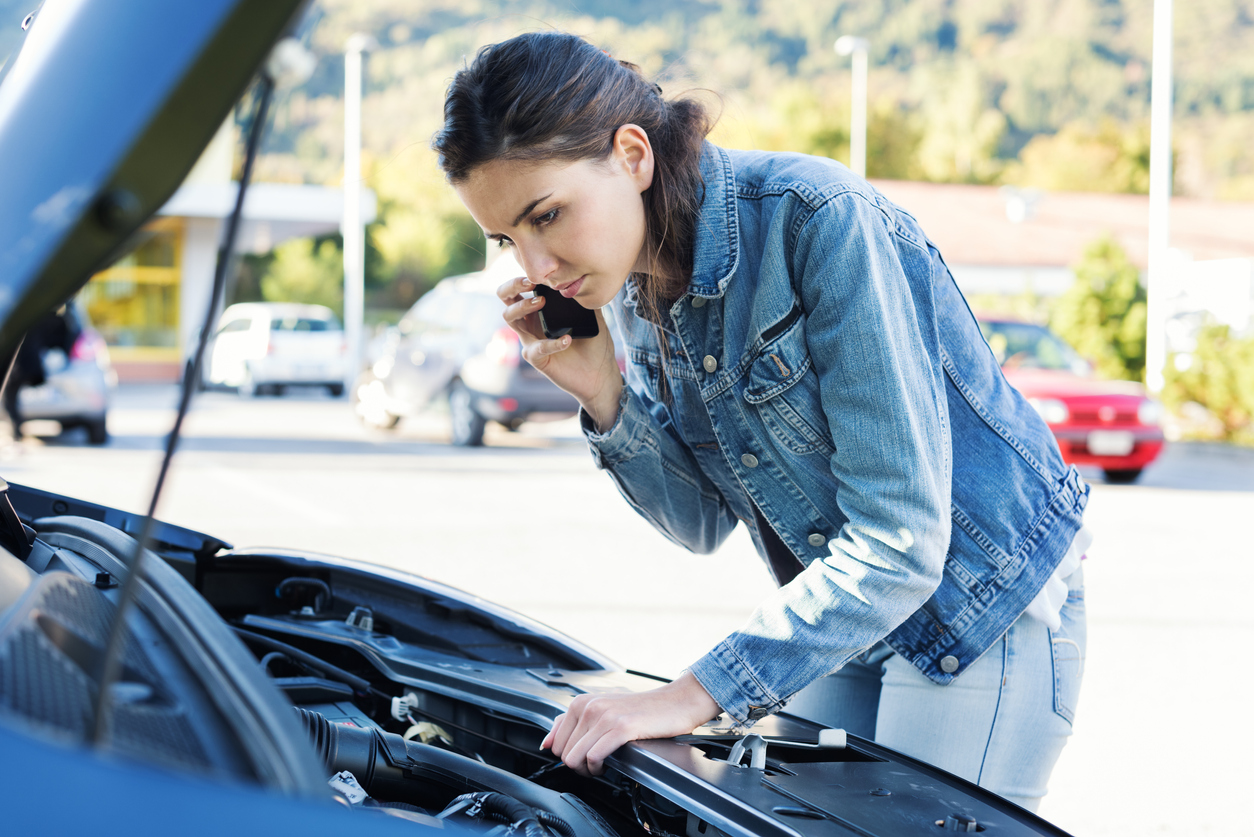 Woman calling car assistance