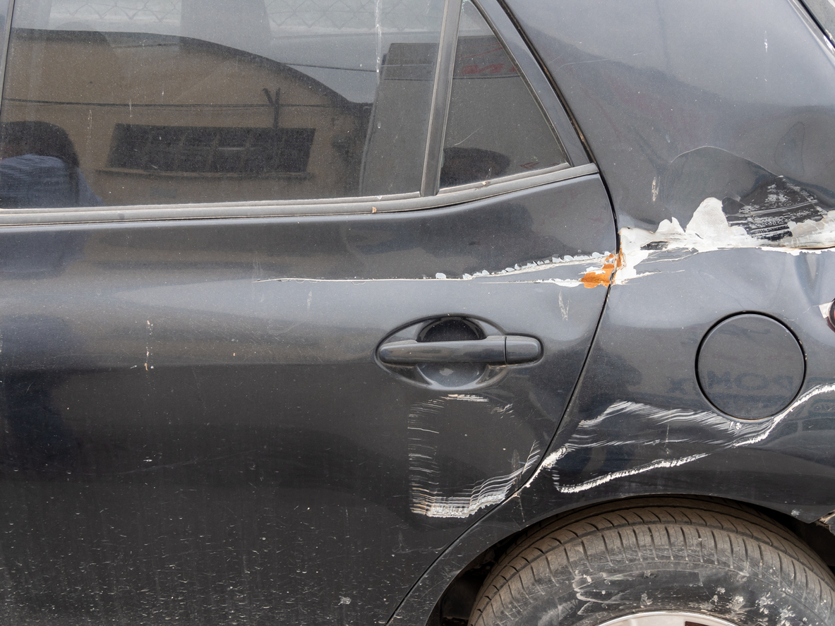 Car with damaged headlight after a sideswipe accident.